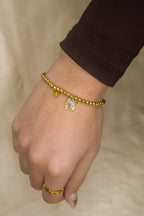 Pulseira dourada com laços