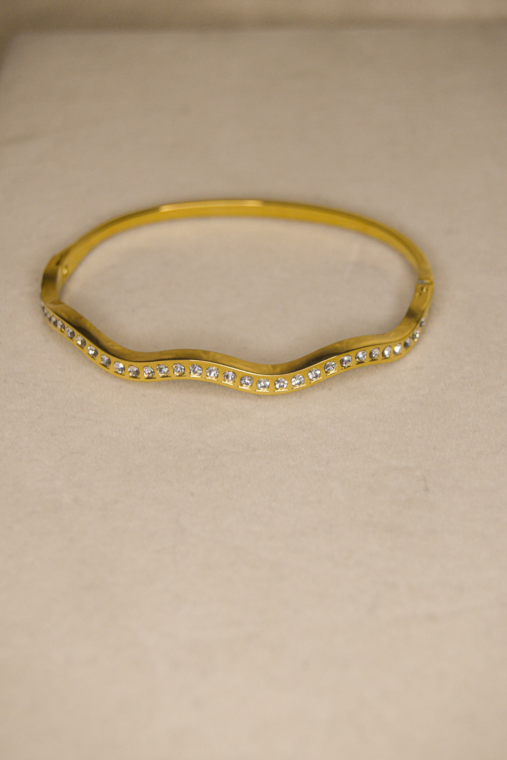 Pulseira dourada com ondas brilhantes